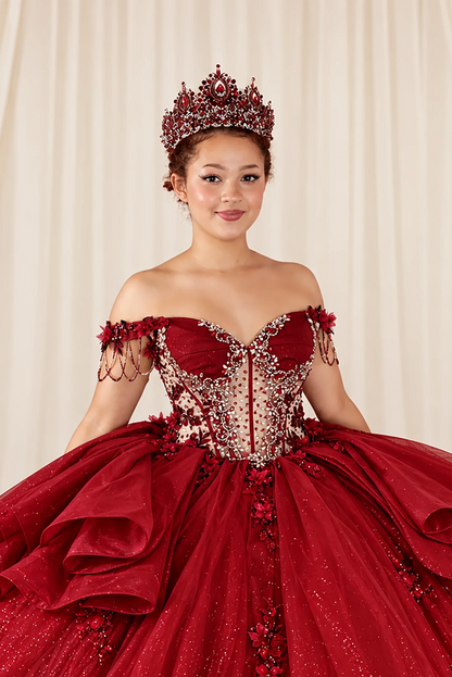 Close-up of the burgundy quinceañera ball gown showing off-shoulder fringe straps and intricate bodice beading.