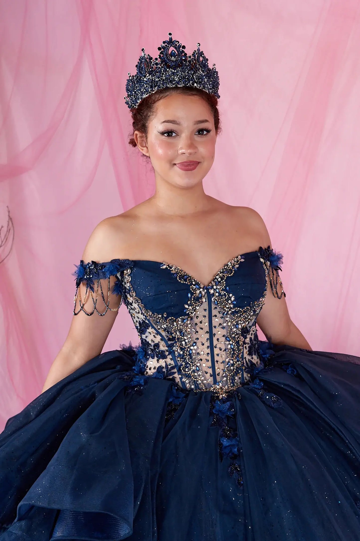 Navy quinceanera ball gown with bead accents, fringe bodice, and shimmering tulle fabric
