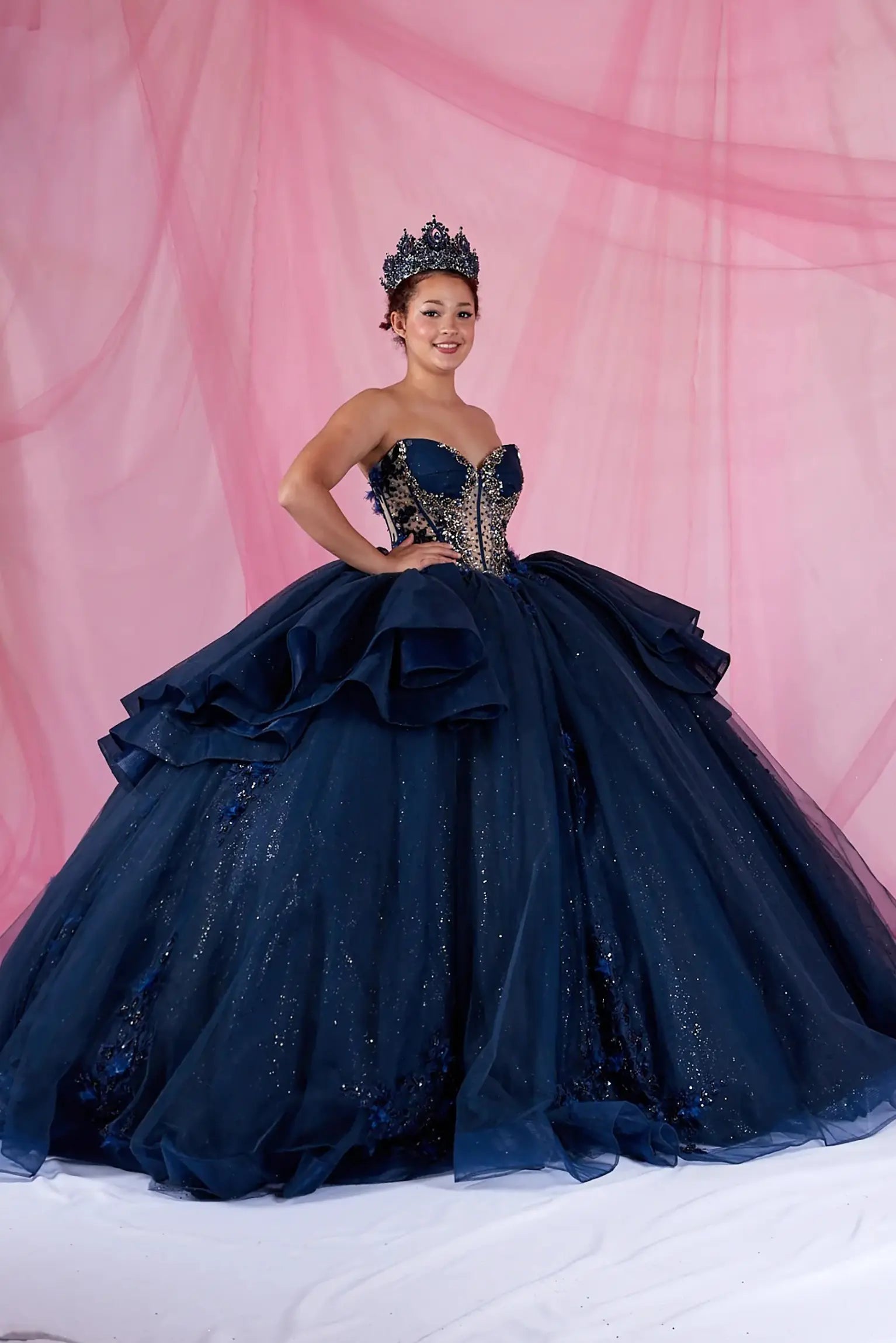 Navy quinceanera ball gown with sweetheart neckline, gold embroidery, bead accents, and fringe bodice detail