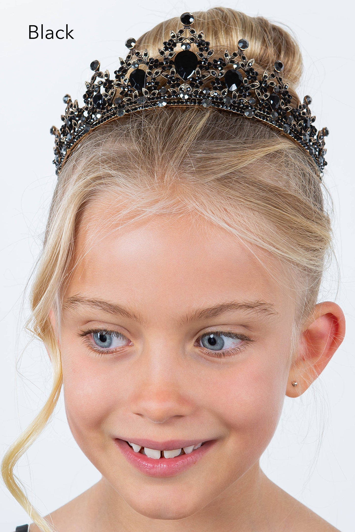 Young girl wearing a black tiara on a white background