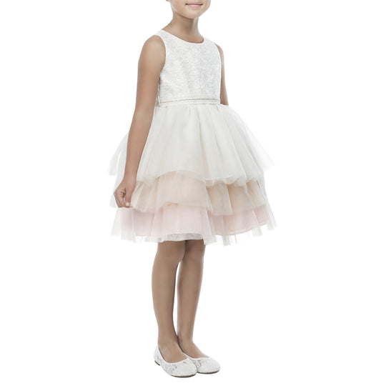 White lace dress with a tulle skirt worn by a young girl on a white background