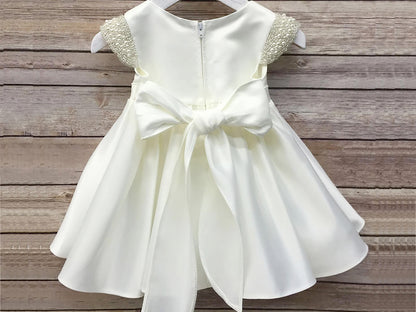 Ivory Flower Girl Beaded Short Sleeves Dull Satin dress with Detachable Pearl Sash - back view of dress with bow