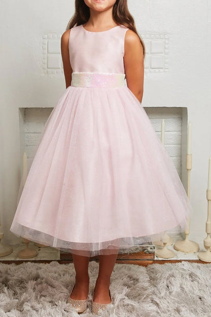 Pink dress worn by a young girl on a neutral background