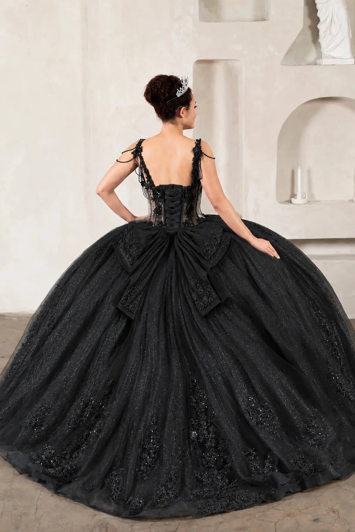 Black quinceañera ball gown with sheer corset bodice, 3D floral embroidery, detachable bow and long train