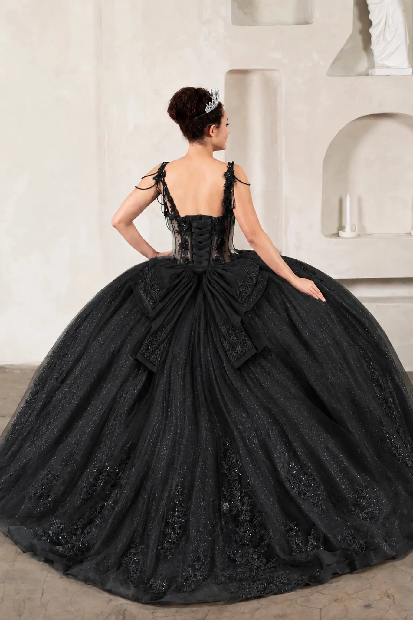 Black quinceañera ball gown with sheer corset bodice, 3D floral embroidery, detachable bow and long train