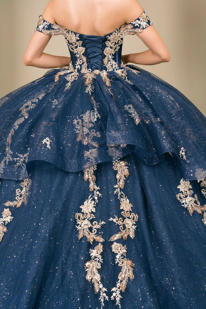 Close-up of woman back-facing in navy quinceañera dress with lace-up corset bodice, gold embroidery, detachable cape layer, and extended train detail