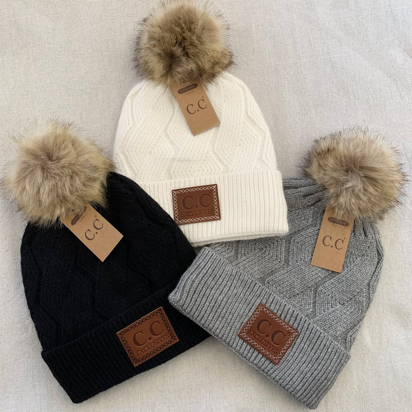 Black ivory gray pom-pom women's winter beanie.