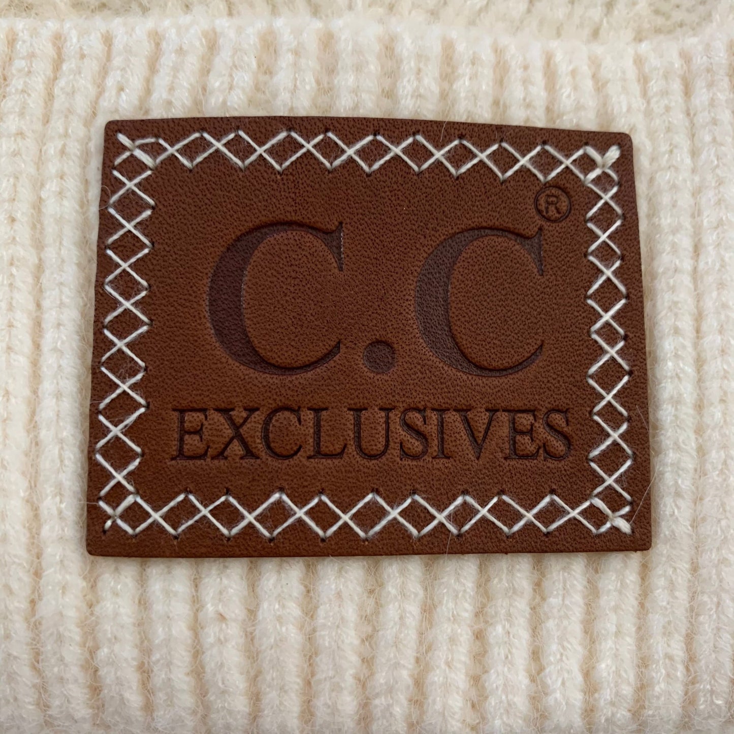 Ivory pom-pom women's winter beanie.