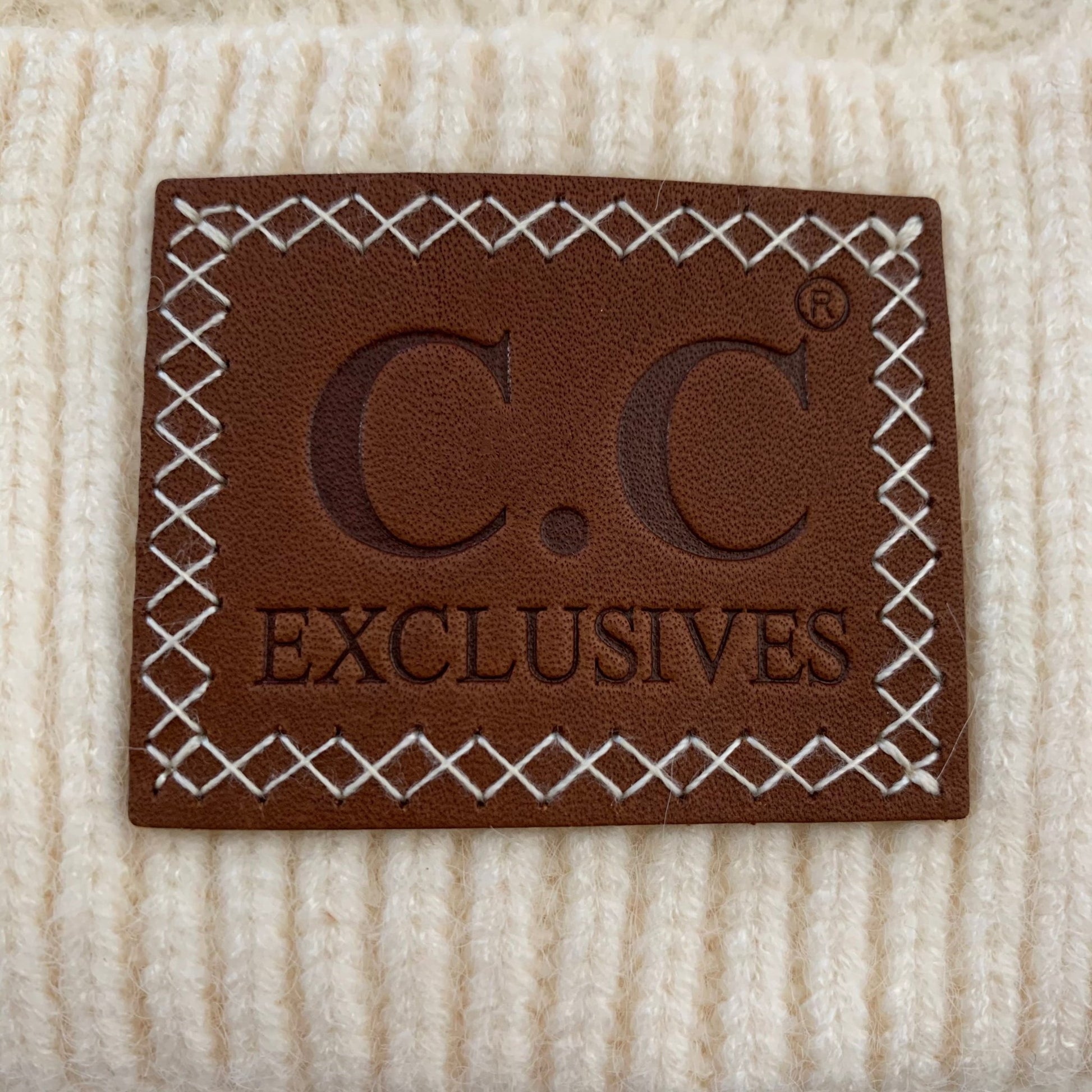 Ivory pom-pom women's winter beanie.