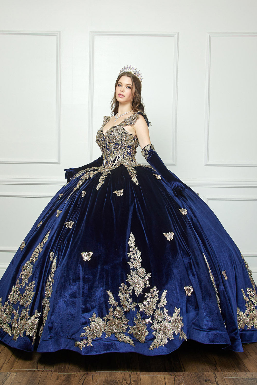 Navy Quinceanera | Off-shoulder Velvet Sweetheart Gold Sequin sequin butterfly floral Ballgown with Sweep train - front/side view of woman wearing dress with hands out to the side