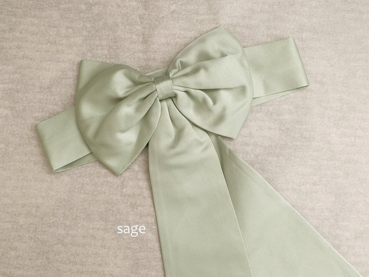 Ornate finishing highlights sage satin flower girl sash belt.