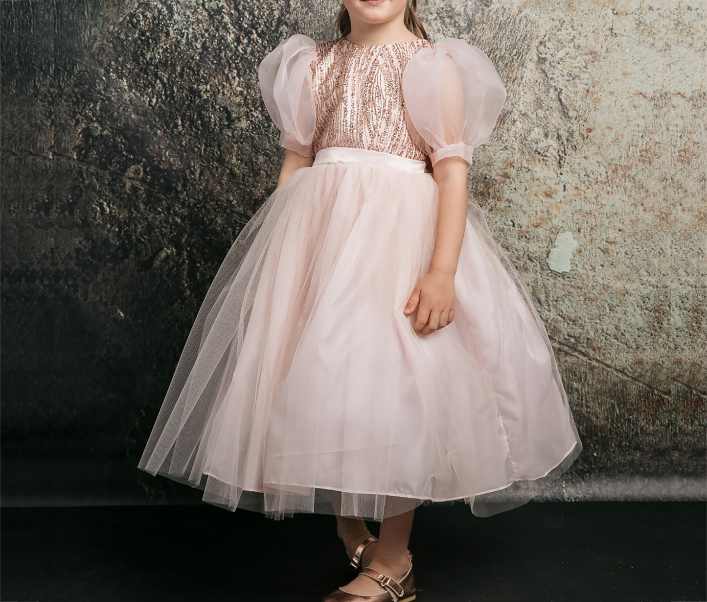 Blush USA Made | Glittering Sequin bodice Luxurious Tulle with Organza Bubble Sleeve Tea-length dress - front/side view of girl wearing dress focusing on skirt with hands at sides