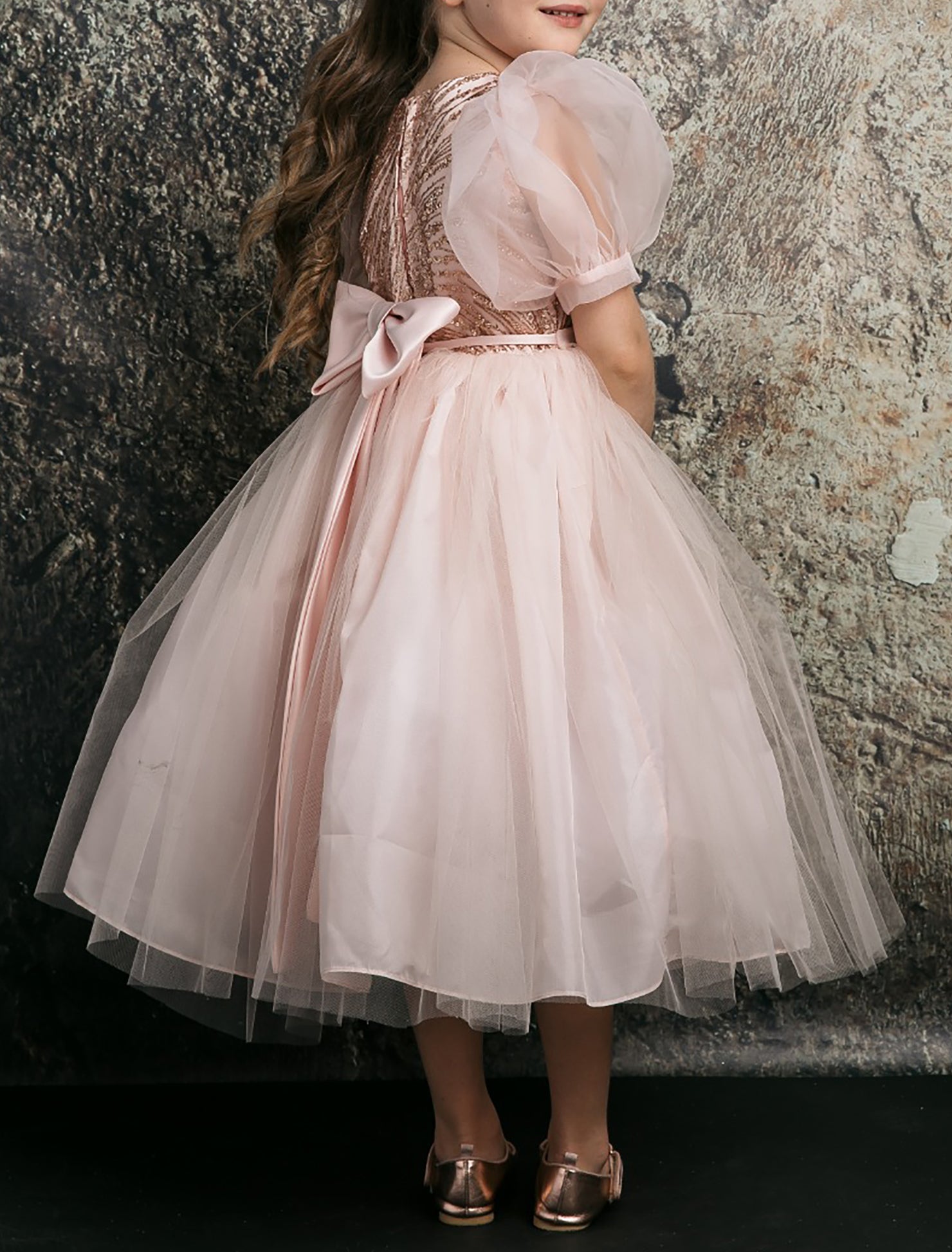 Blush USA Made | Glittering Sequin bodice Luxurious Tulle with Organza Bubble Sleeve Tea-length dress - back zoomed view of girl wearing dress focusing on bow and skirt