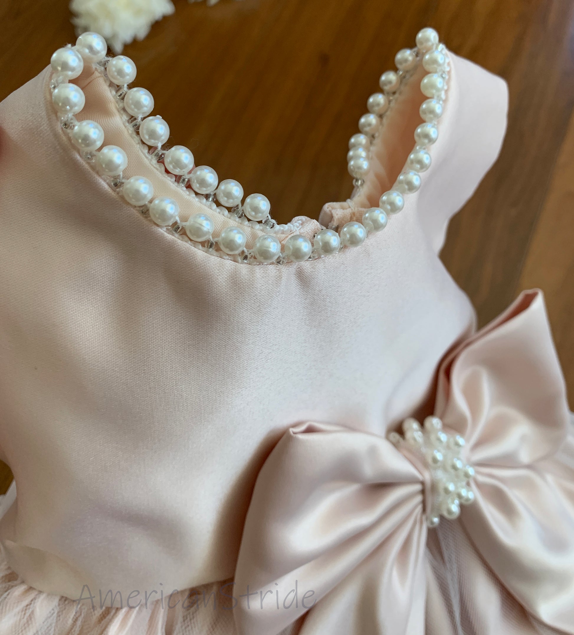 Blush USA Made | Pearl Neckline & Pearl detail Bow Satin and Tulle Flower Girl Dress - zoomed in view of pearls on neckline