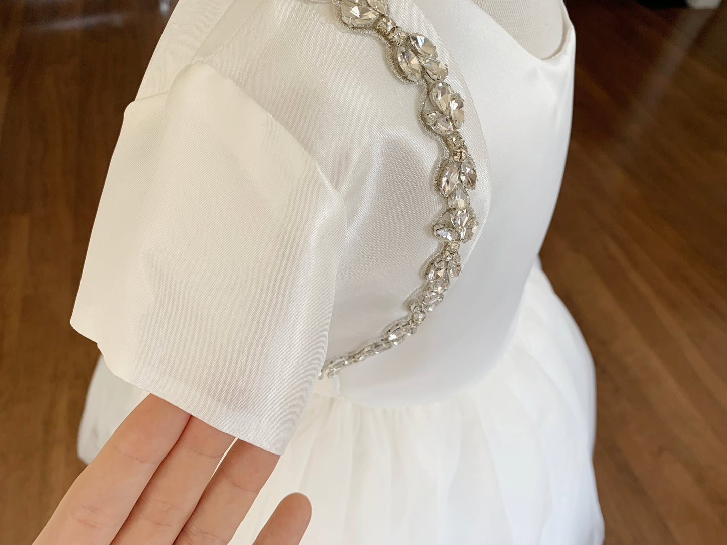 Ivory rhinestone taffeta first communion bolero, close-up, side view, embellishment detail.
