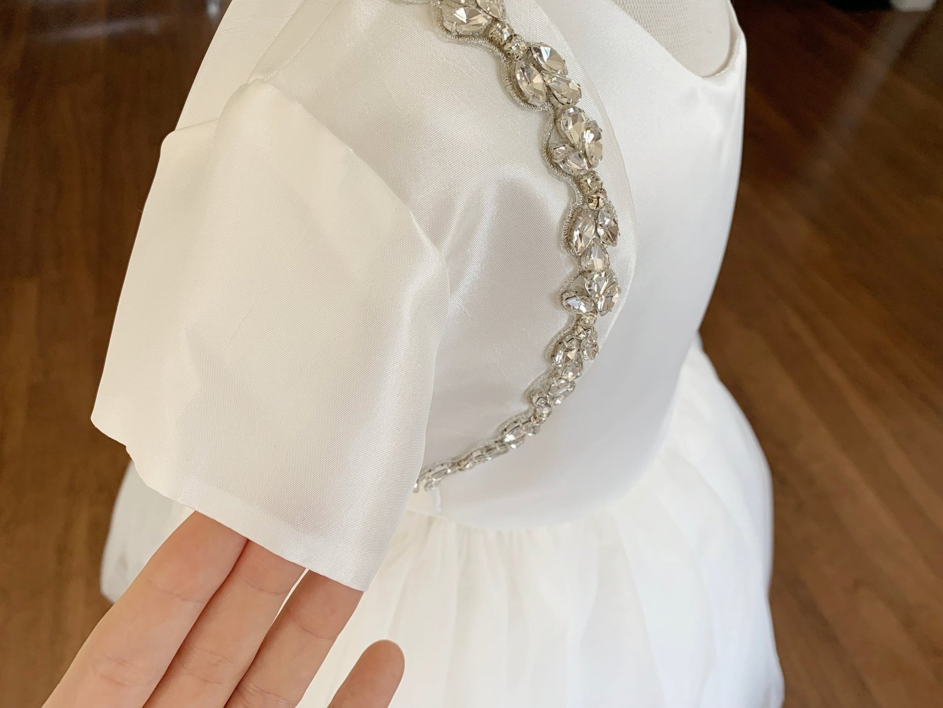 Ivory rhinestone taffeta first communion bolero, close-up, side view, embellishment detail.