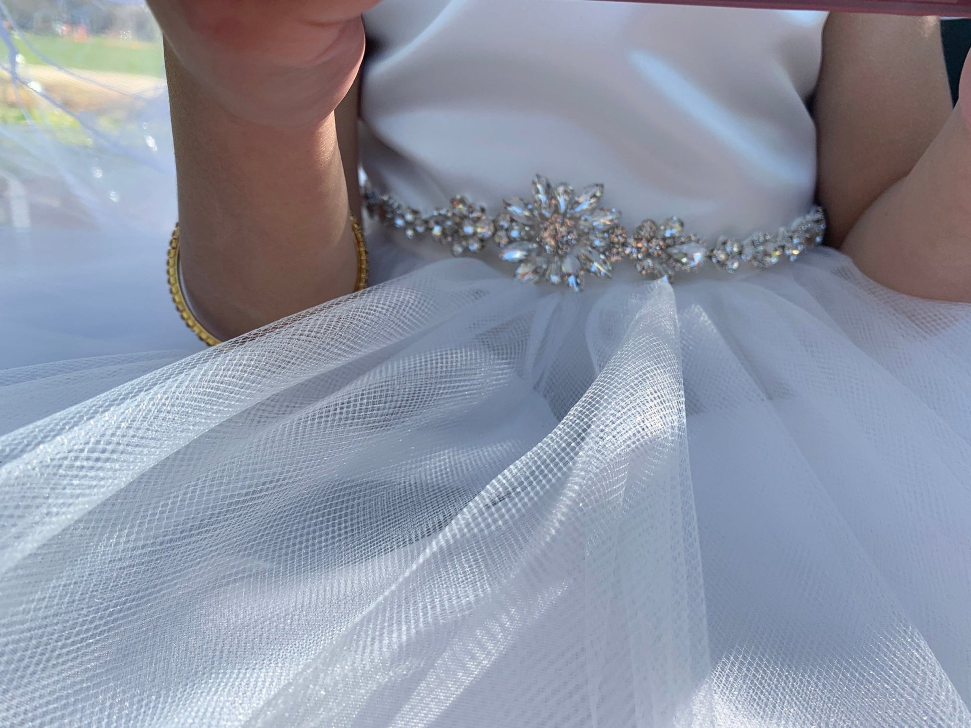 Silver rhinestone floral flower girl sash belt, close-up, embellishment detail.