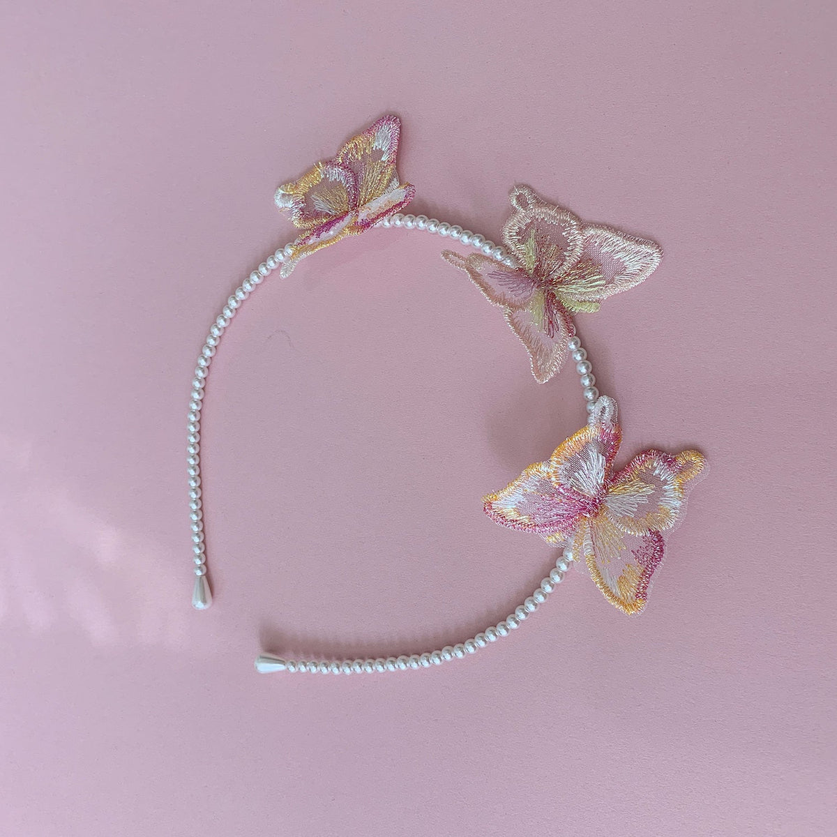 Multi color pearl butterfly flower girl headband or hair clips, side view.