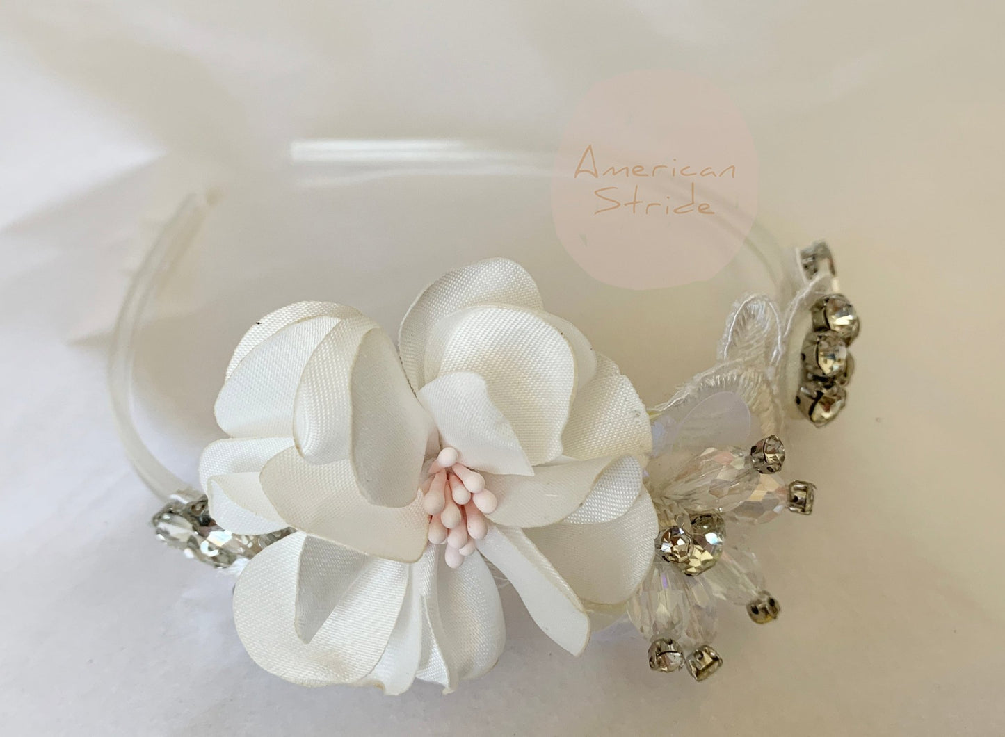 Ivory rhinestone floral flower girl headband, close-up, embellishment detail.