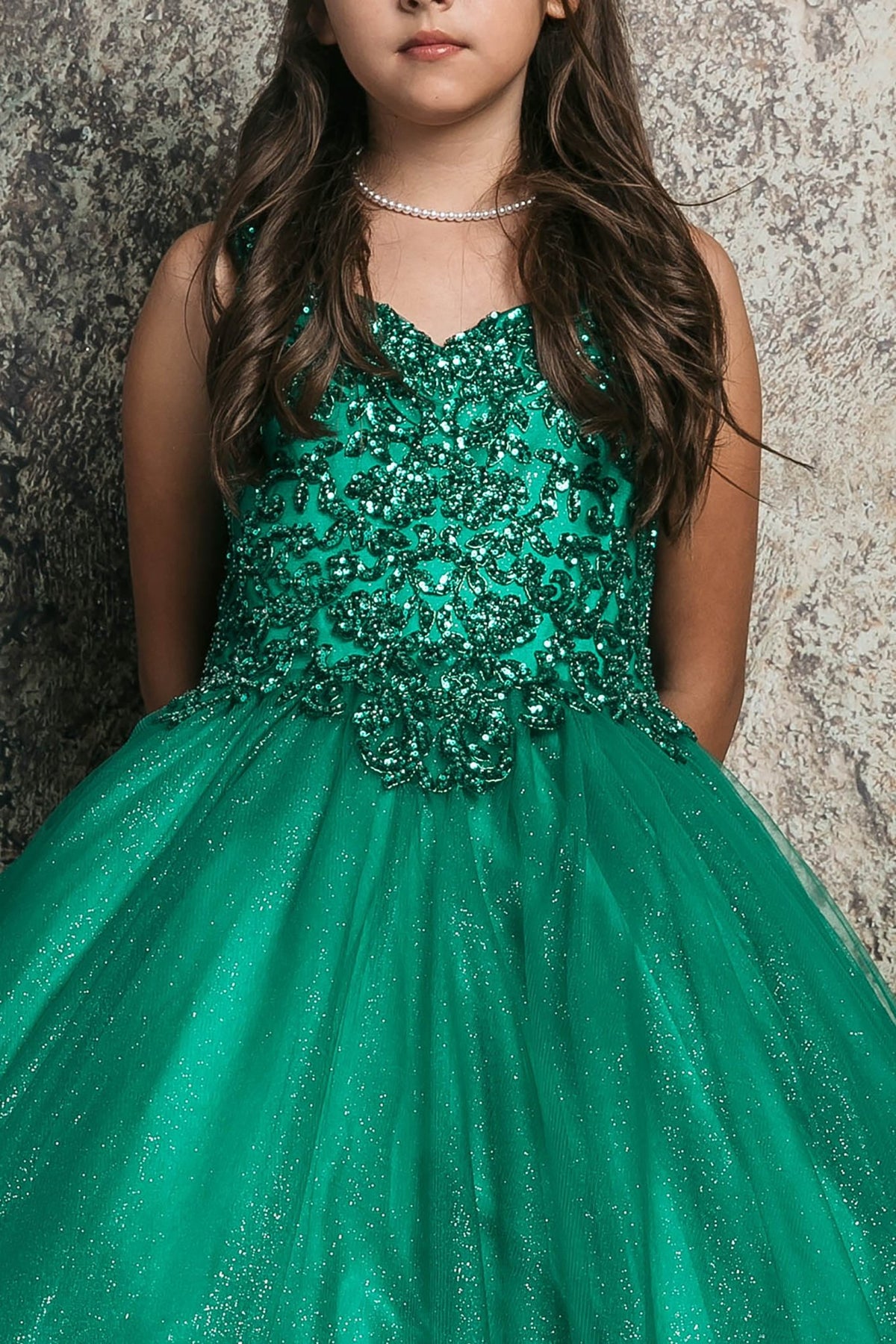 Zoomed front view of a green kids mini quinceanera mini quince dress highlighting sequin beaded embroidery bodice and glitter tulle skirt.
