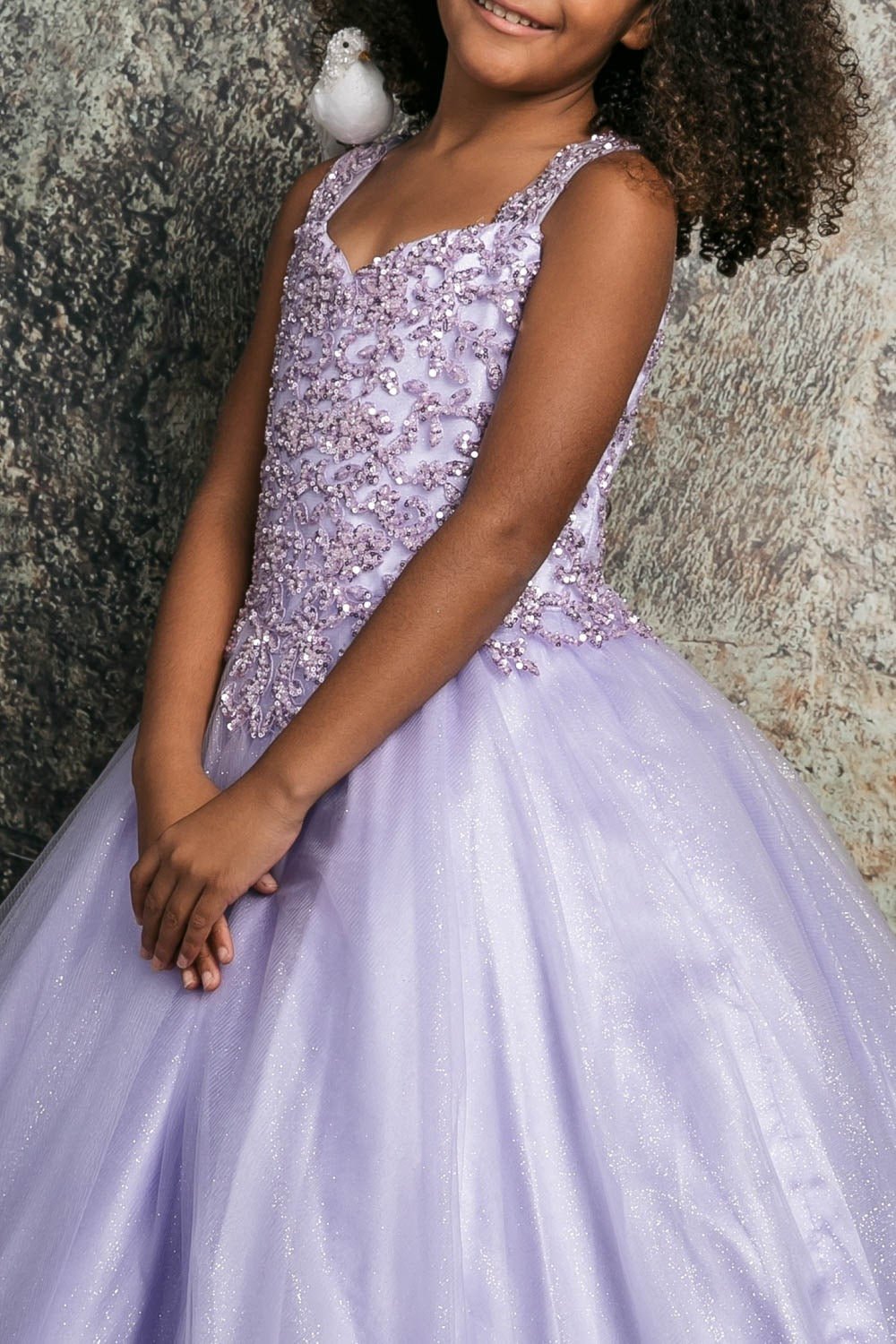 Side close-up of a lilac kids mini quinceanera mini quince dress showing sequin beaded embroidery bodice and glitter tulle fabric.