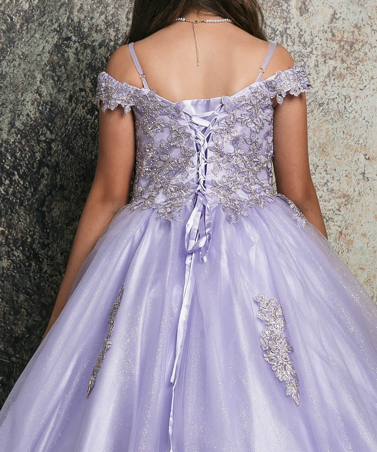 Back close -up view of a lilac kids mini quinceanera mini quince dress with lace corset bodice and floral appliques.