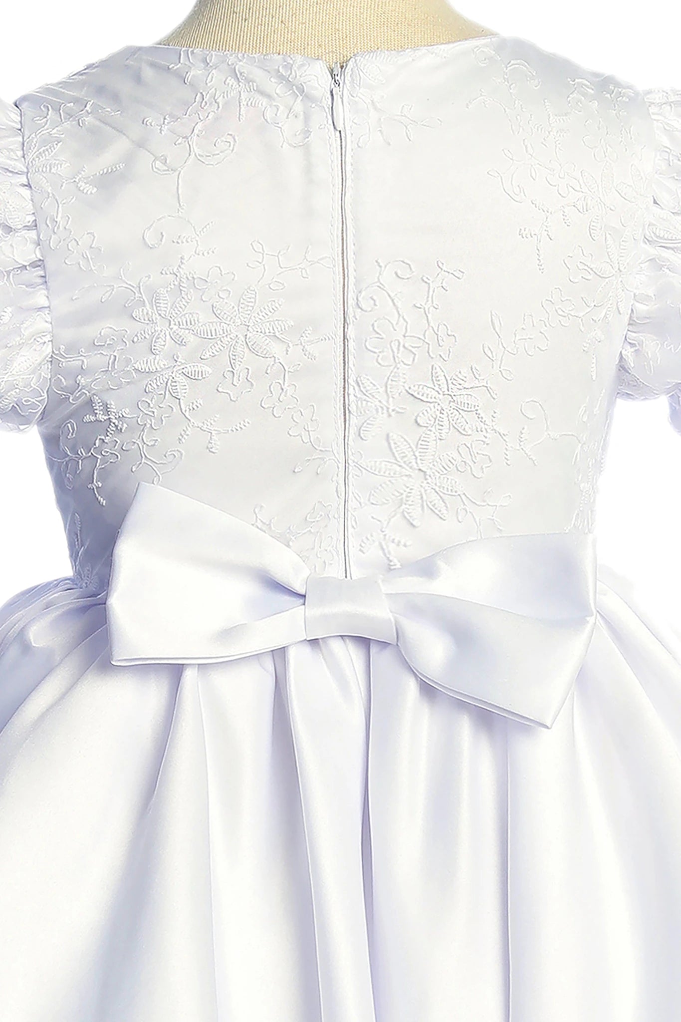 White lace flower girl dress with a large bow. Also suitable as a communion dress.