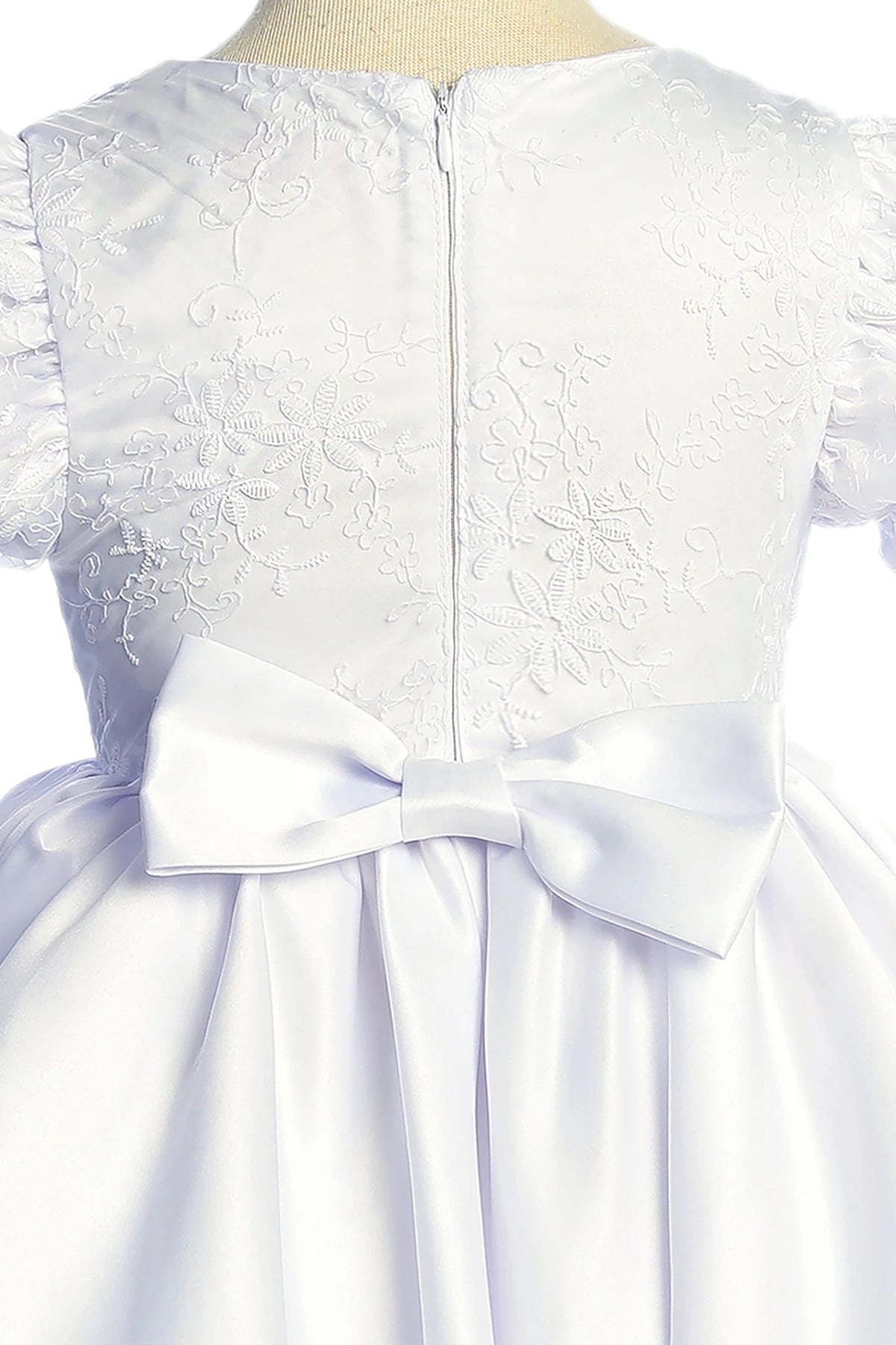 White lace flower girl dress with a large bow. Also suitable as a communion dress.