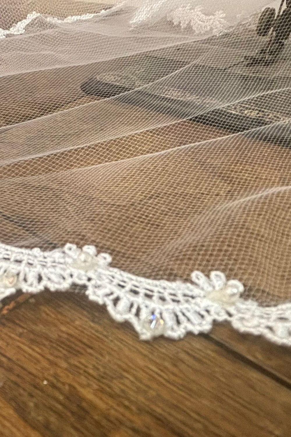White pearl rhinestone lace first communion veil, close-up, embellishment detail.