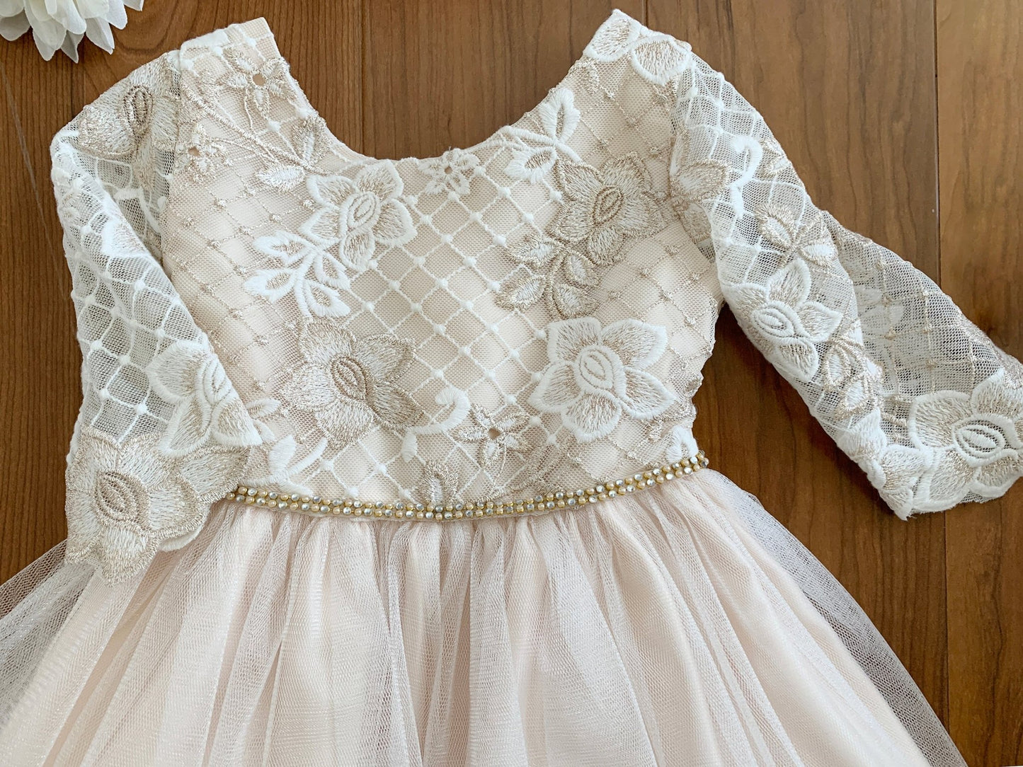 Lace dress with long sleeves on a wooden background