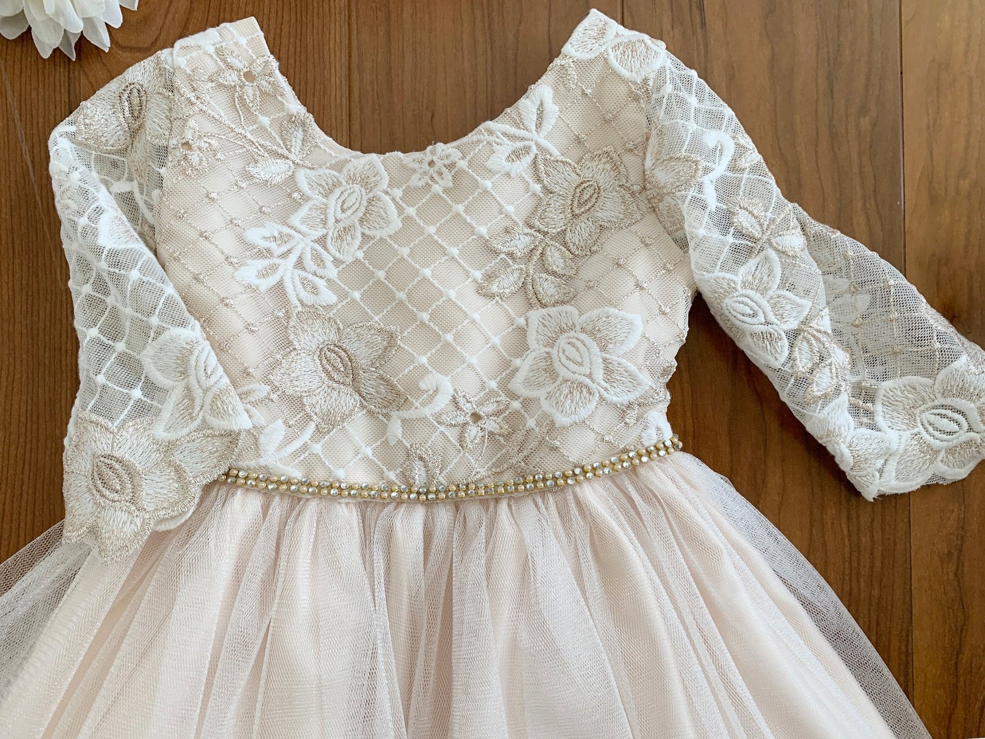 Lace dress with long sleeves on a wooden background