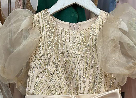 Champagne USA Made | Glittering Sequin bodice Luxurious Tulle with Organza Bubble Sleeve Tea-length dress - zoomed in view of front of dress on hanger