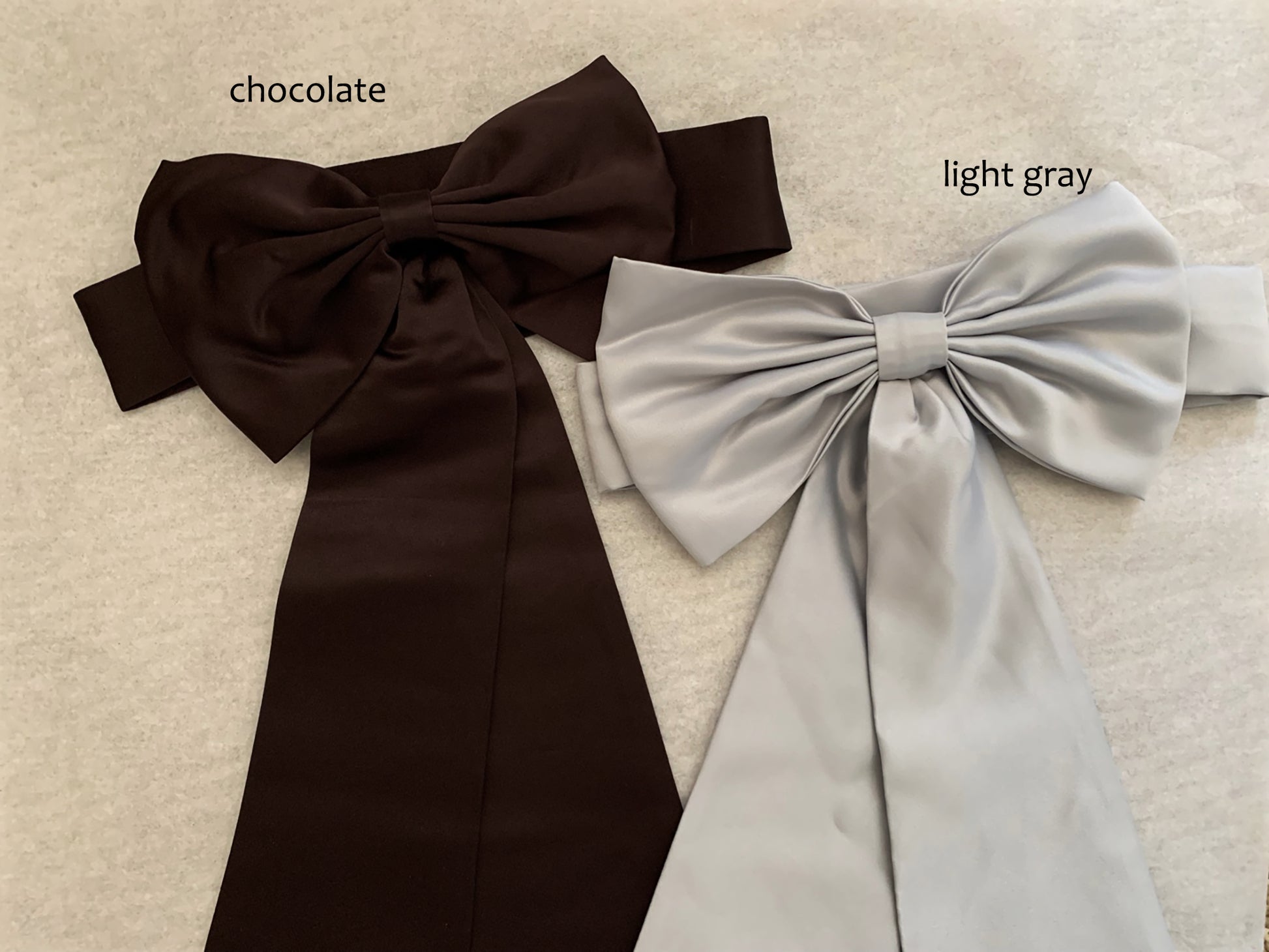 chocolate and light gray ribbons on ivory background