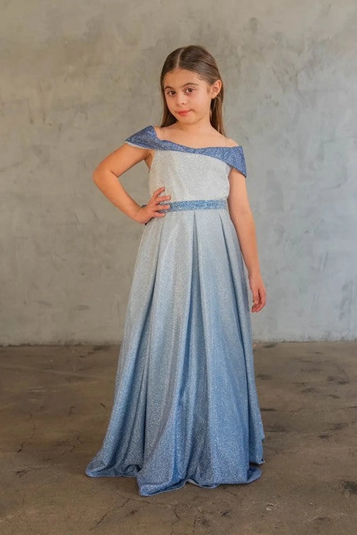 This second view emphasizes off-the-shoulder neckline with an oversized back bow on the Blue/Silver mini quince dress.