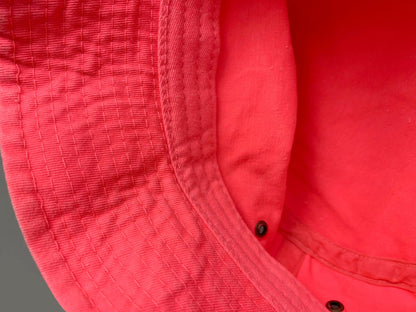 Bodice close-up highlights coral everyday women's bucket hat, interior detail.