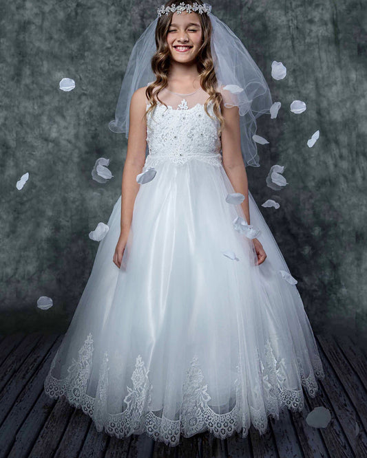 Young girl in a white lace dress with a veil against a dark background