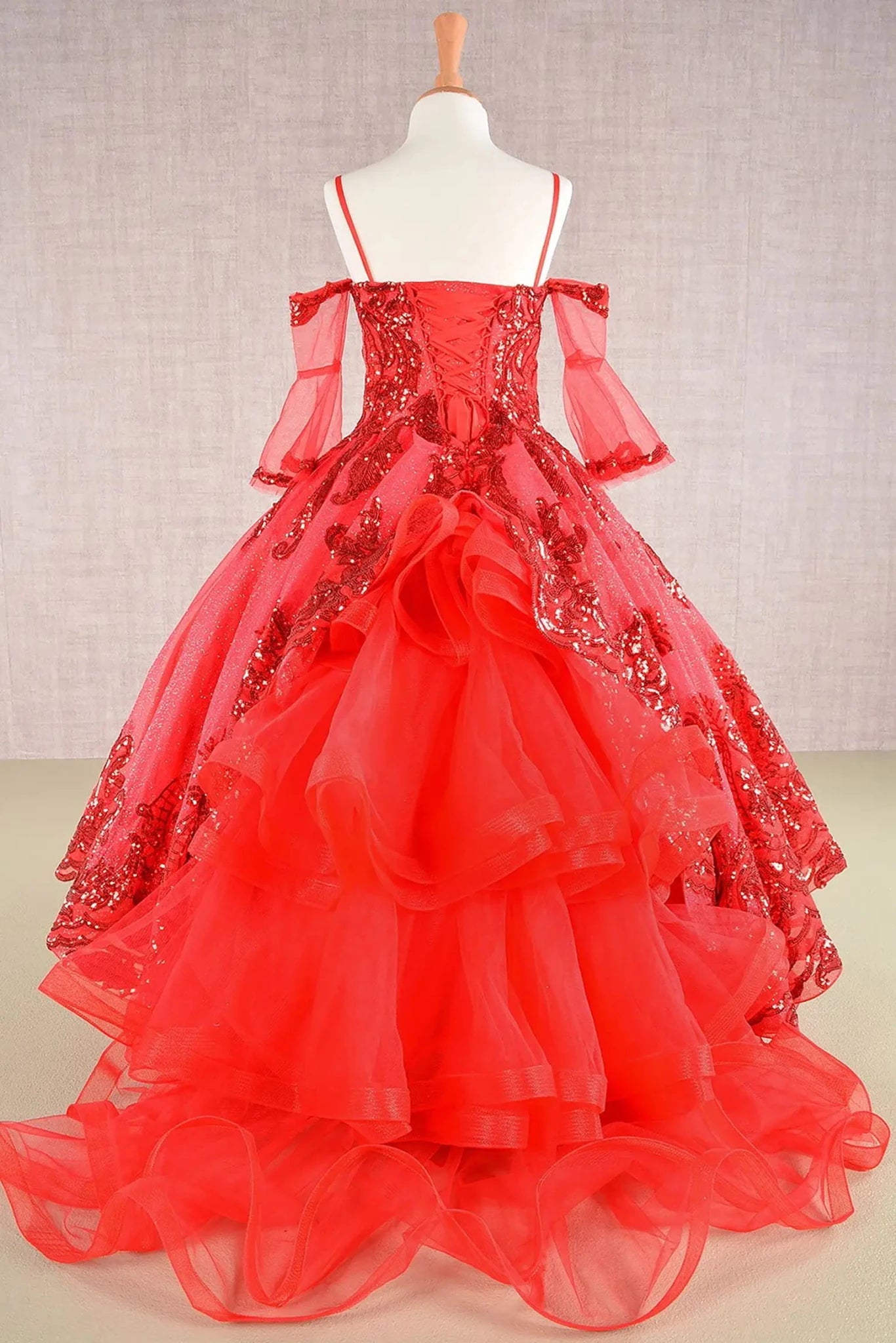 Red kids mini quinceañera mini quince dress with glitter sequin mesh bodice, layered tulle skirt, and detachable three-quarter sleeves.