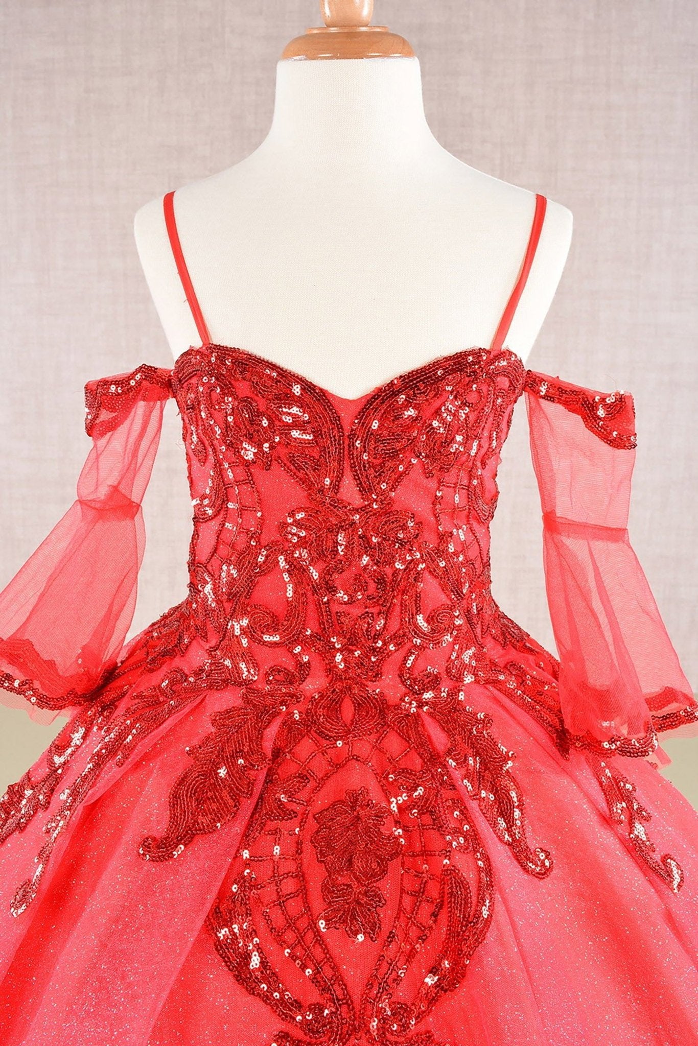 Front zoom view of a close-up of red glitter sequin mesh bodice with separate 3/4 mesh sleeves. Mini quince dress.
