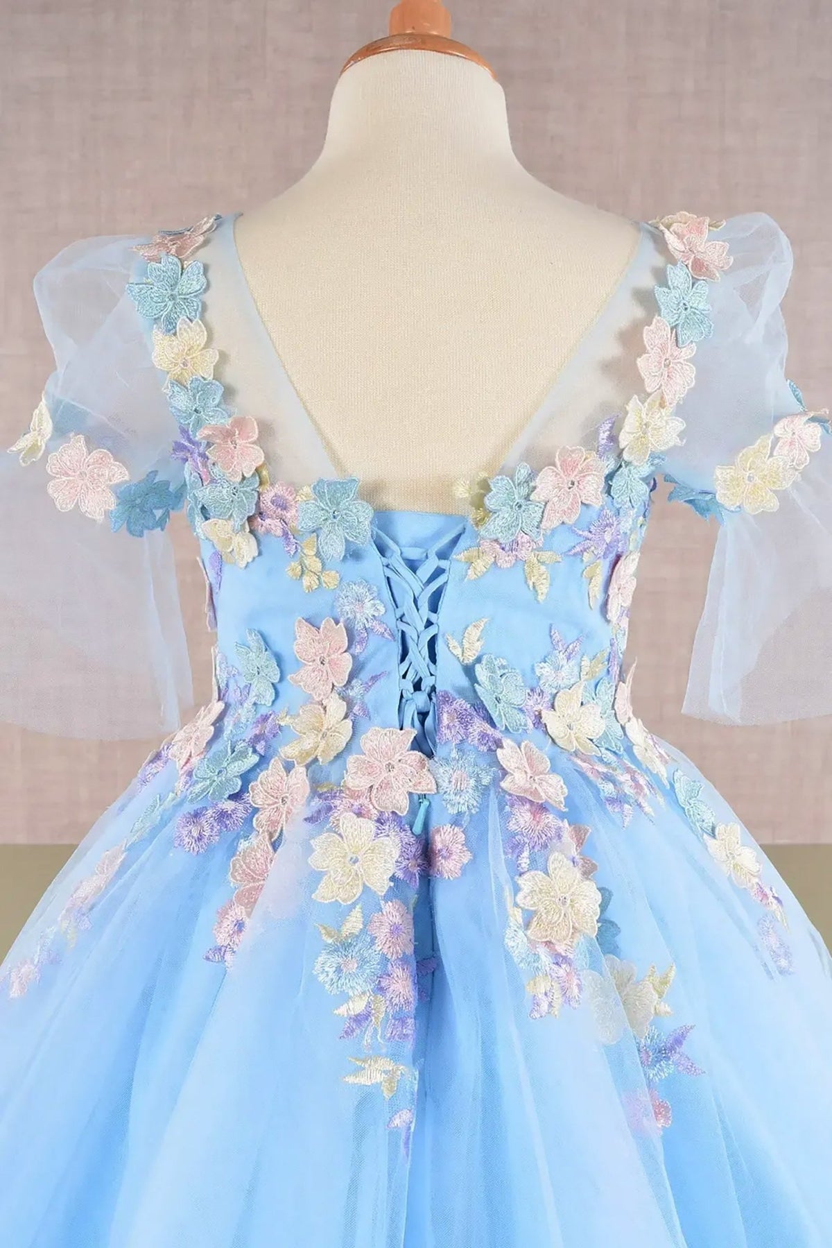 Close-up of blue Baby Blue Kids Dress with 3D Floral Applique, Puff Sleeves and Back Hem, Mini Quince Dress.