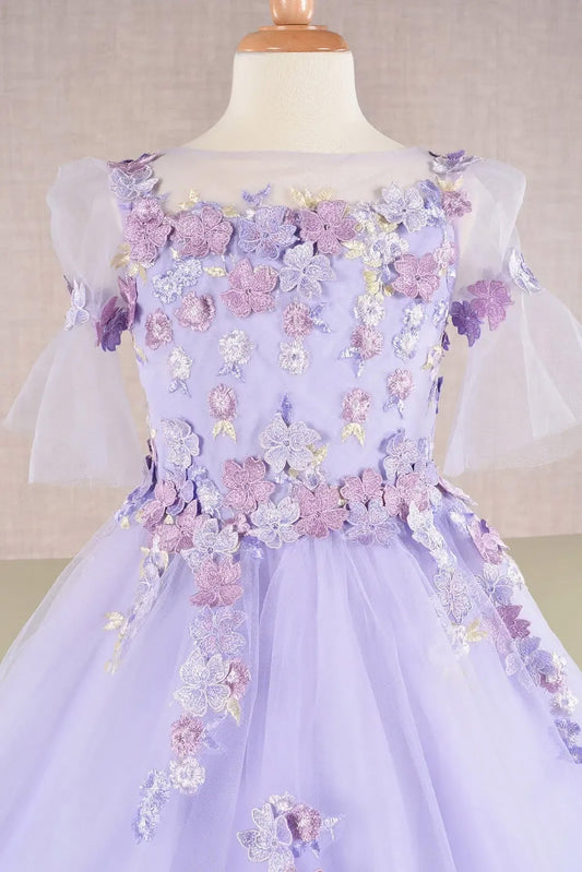 Front zoom view of a lilac kid ballgown with 3D floral applique, puff sleeves, and glitter tulle details