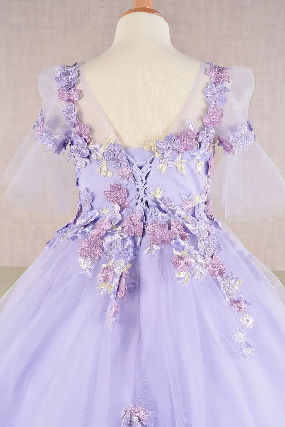 Close-up of Lilac Kids Dress with 3D Floral Applique, Puff Sleeves and Back Hem, Mini Quince Dress.