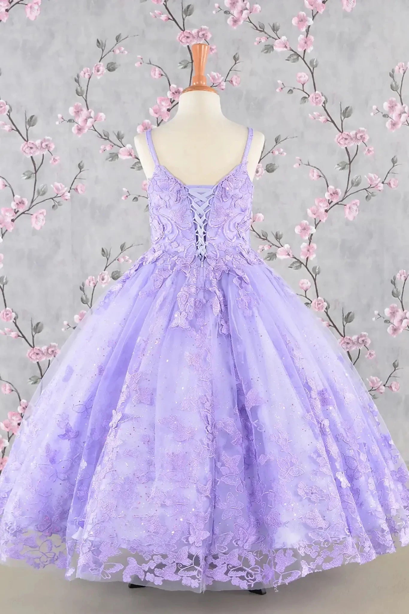 Back view of lilac lace mini quince dress displayed.