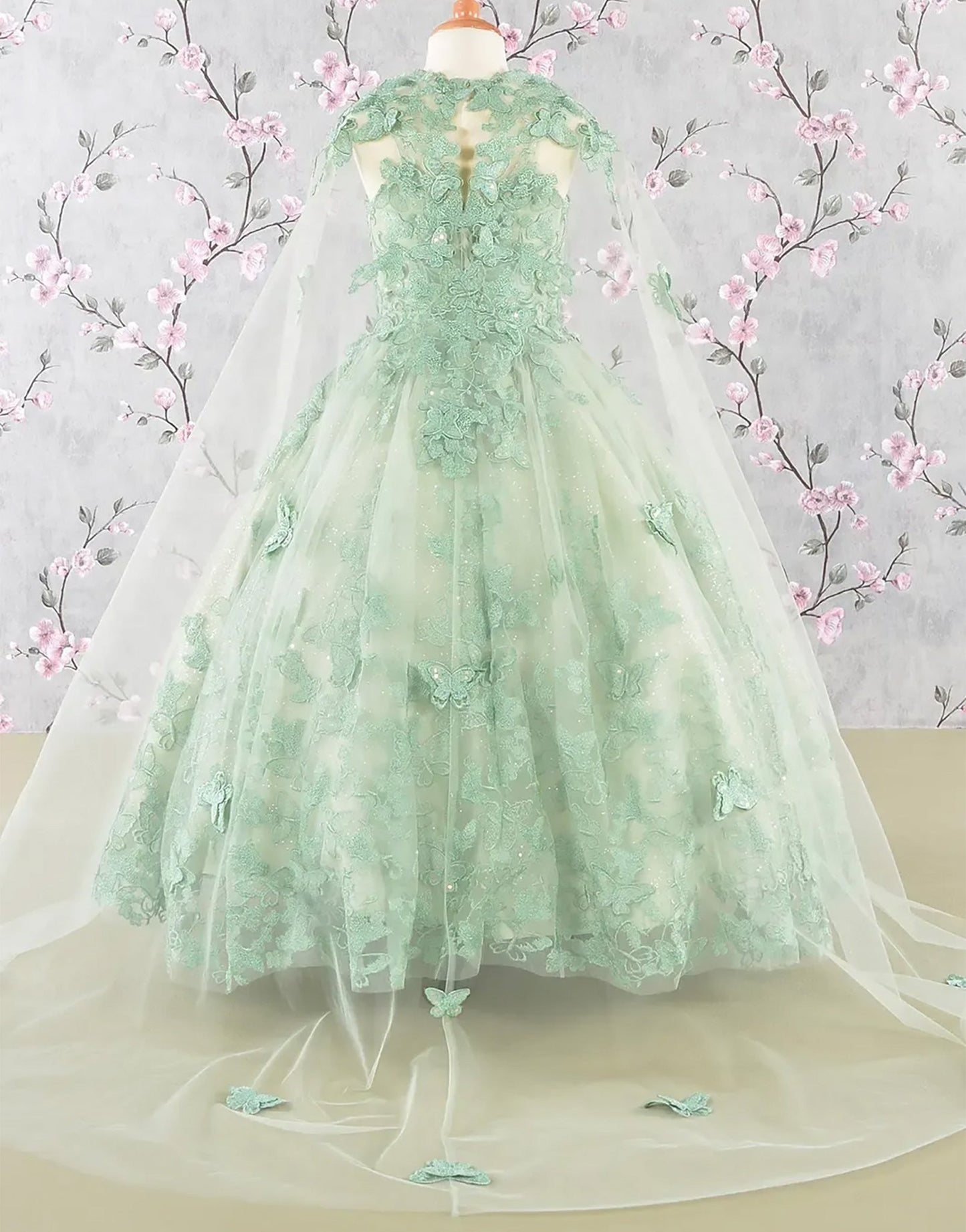 Green lace mini quince dress displayed.