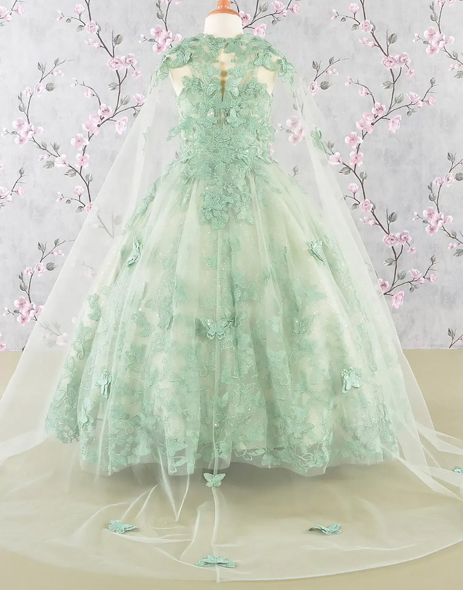 Green lace mini quince dress displayed.