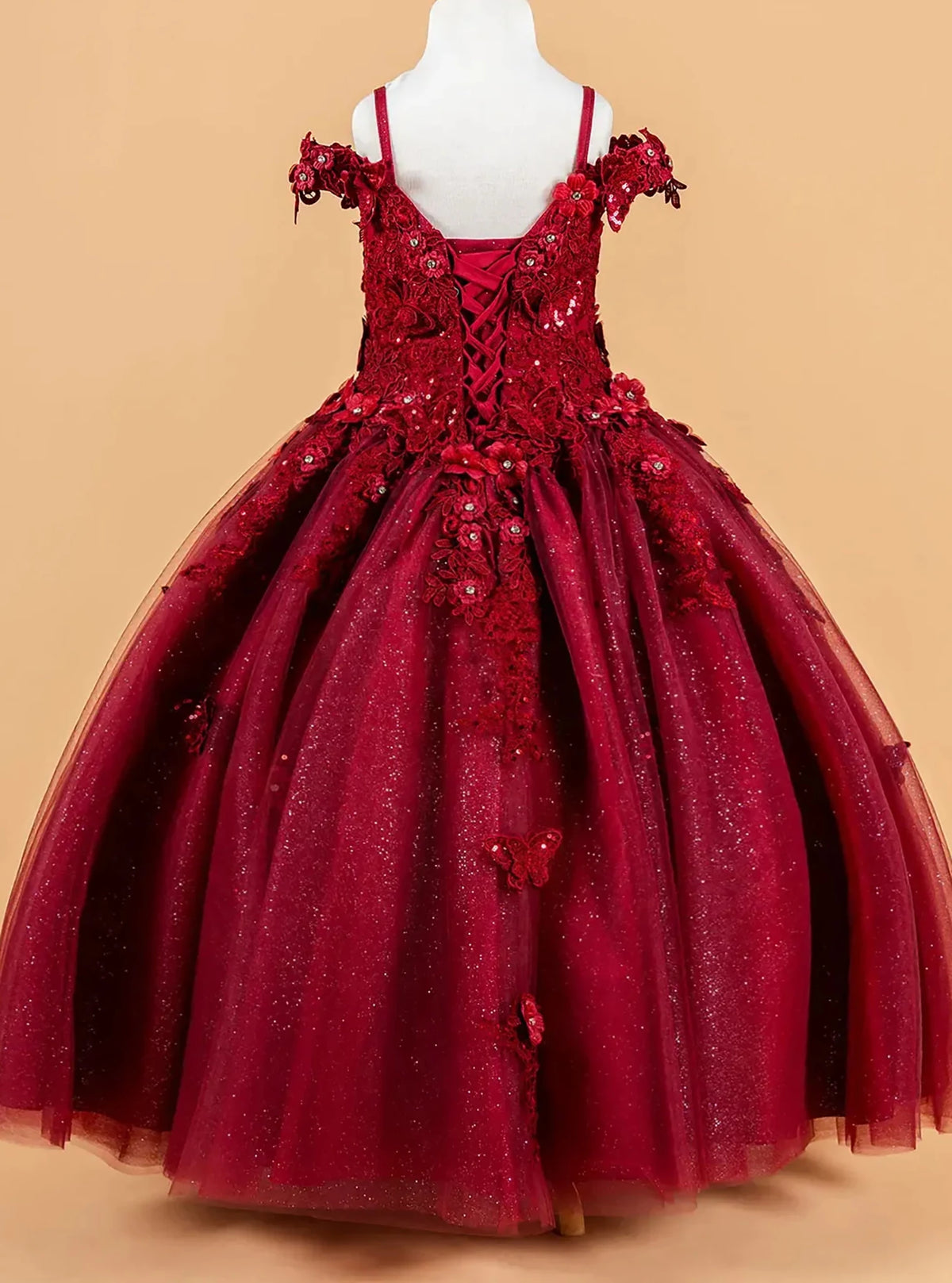 Red kids mini quince dress with floral applique details.