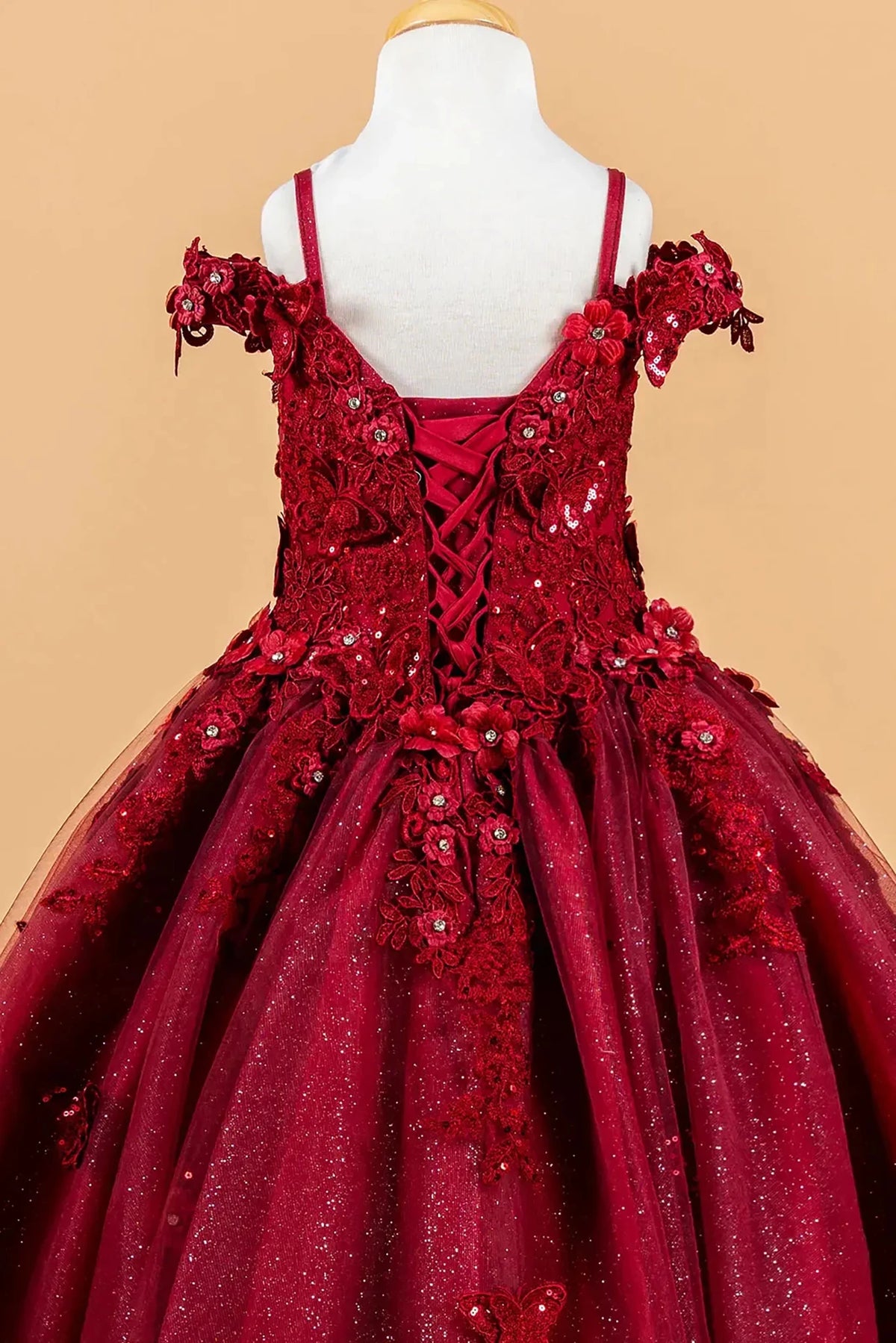 Red kids lace mini quince dress with floral applique details.