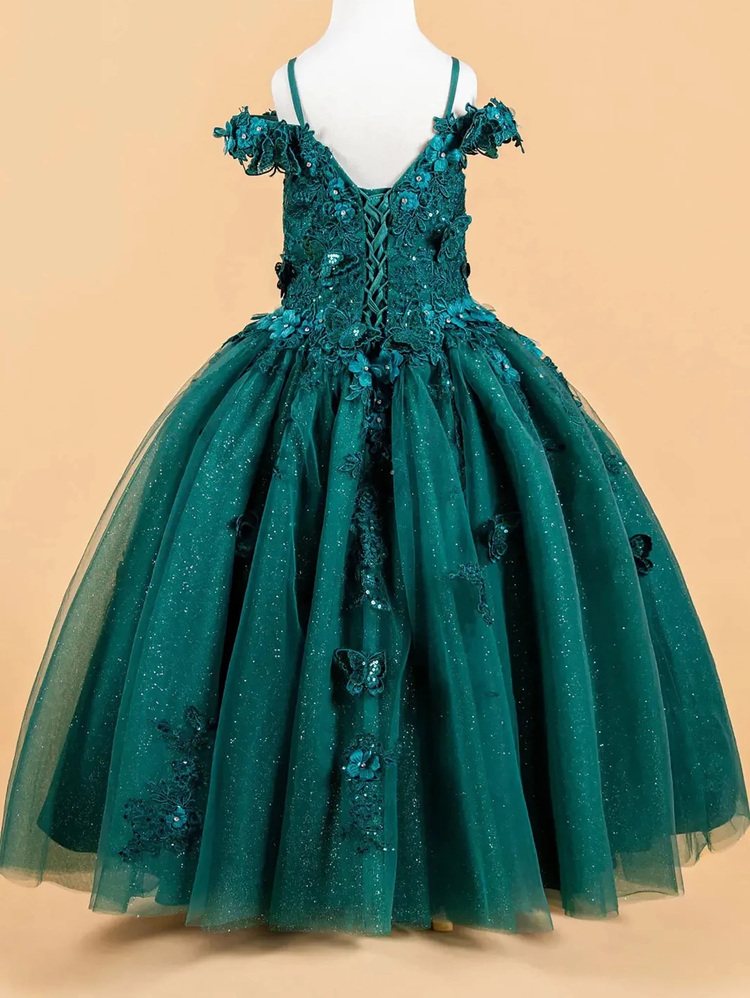 Green sequin mini quince dress displayed.