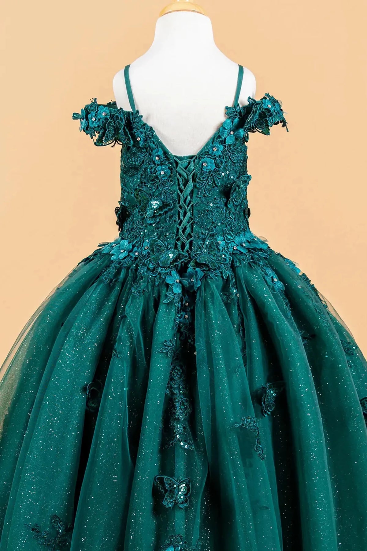 Green kids evening mini quince dress with floral applique details.