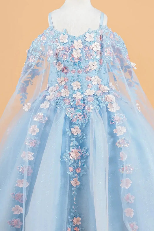 Blue kids mini quinceañera mini quince dress with 3D floral applique bodice, cold shoulder sleeves, glitter tulle skirt, and sheer cape overlay.