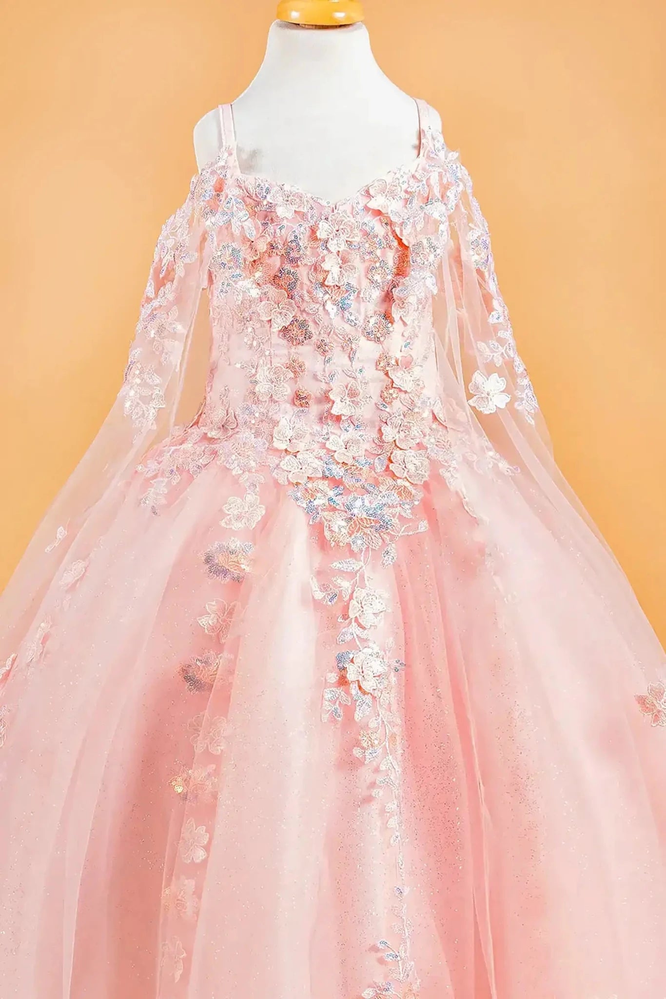 Blush kids floral mini quince dress featuring long lace sleeves, floral appliques, and an elegant train.